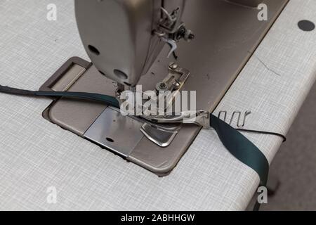 seamstress works on the sewing machine, clos up Stock Photo
