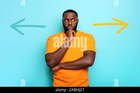 Man is undecided about the right way to follow Stock Photo - Alamy