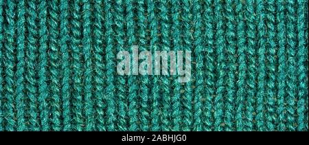 Green knitting wool texture. Cloth background close up Stock Photo