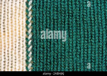 Green and white knitting wool texture. Cloth background close up Stock Photo