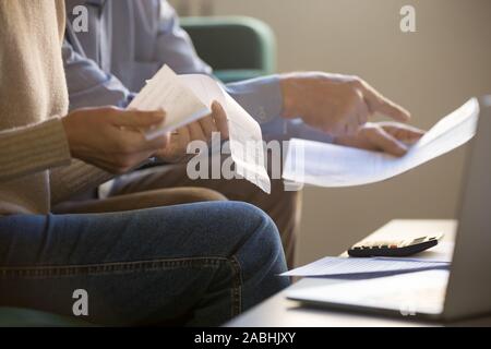 Spouses manage family budget check bills cheques closeup cropped image Stock Photo