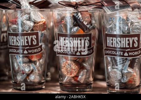 Hershey, PA / USA - November 26, 2019:  Various Milk Chocolates in souvenir glasses on display and for sale in Hershey’s Chocolate World. Stock Photo