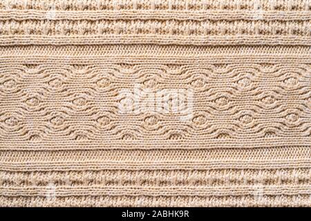 Beige Knitwear Fabric Texture with Pigtails. Beige Knitted Background. Stock Photo
