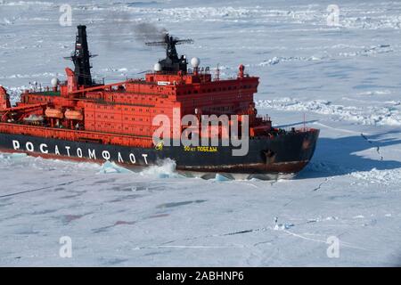 Russia. Aerial view of Russian nuclear icebreaker, 50 Years of Victory breaking throug pack ice in High Arctic at 85.6 degrees north on the way to the Stock Photo