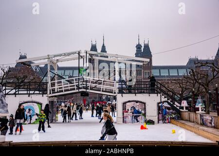 Amsterdam Holland December 2018 winter scating and taking pictures outdoors on the frozen pond in front of the Rijksmuseum including the white drawbri Stock Photo