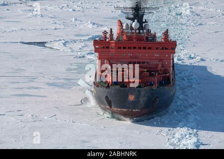 Russia. Aerial view of Russian nuclear icebreaker, 50 Years of Victory breaking throug pack ice in High Arctic at 85.6 degrees north on the way to the Stock Photo