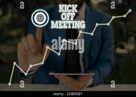 Conceptual hand writing showing Kick Off Meeting. Concept meaning getting  fired from your team private talking about company Leaves surrounding  notepaper above empty soft pastel table Stock Photo