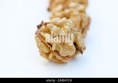 Peeled walnut closeup. Golden walnut kernel on a white background. Healthy foods. Stock Photo