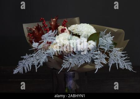 Christmas and New Year composition bouquet in a glass vase on a dark background, selective focus Stock Photo