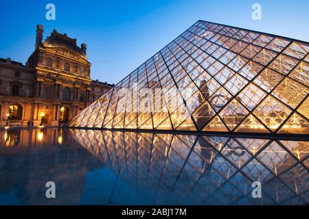 PARIS, FRANCE - JULY 6: The Louvre Pyramid at dusk during the Michelangelo Pistoletto Exhibition on July 6, 2013 in Paris Stock Photo