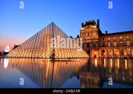 Editorial: PARIS, FRANCE - JULY 6: The Louvre Pyramid at dusk during the Michelangelo Pistoletto Exhibition on July 6, 2013 in Paris
