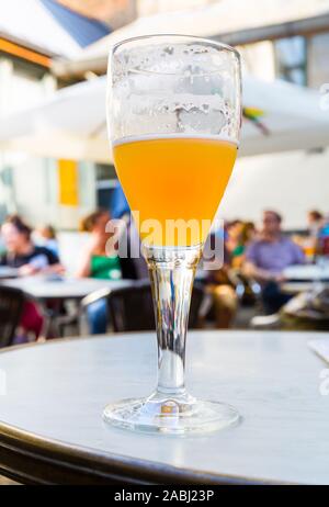 Beer in glass on table in street cafe, Europe Stock Photo