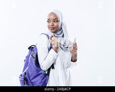 portrait of happy african modern muslim female student standing against white background wearing traidiional sudan muslim hijab fashion Stock Photo