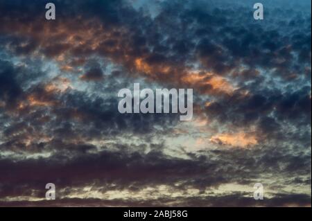 Altocumulus Perlucidus clouds toward sunset in dramatic sky. Stock Photo