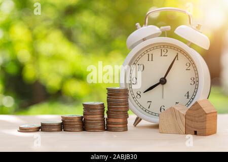 Home Maintenance fee or Saving money for buy a new house with Time Clocks for future concept.