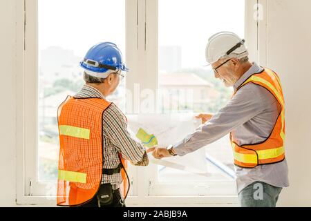 Happy professional worker working together home builder architecture mix race in construction site Stock Photo