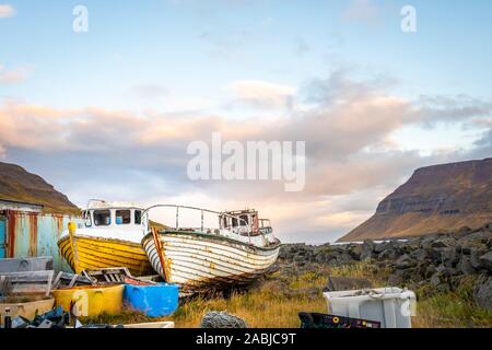 Yellow and white fishing boats under repair, Sudureyri, Iceland Stock Photo