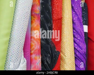 Bolts of Glittery Fabric on Display in a Fabric Store. Stock Photo