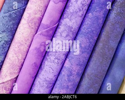 Bolts of Purple Fabric on Display in a Fabric Store. Stock Photo
