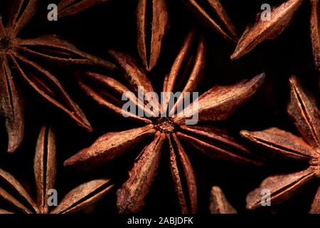 Pattern of Badyan star anise seeds close up at the market in India Stock Photo