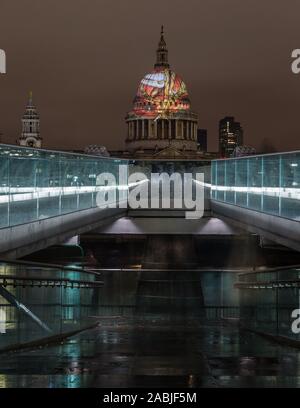 The view from Millennium Bridge of 'Ancient of Days' by William Blake projected on to dome of St Paul's Cathedral in background Stock Photo