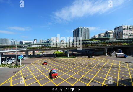 Red Taxis crossing a busy intersection in West Kowloon, Hong Kong. Stock Photo