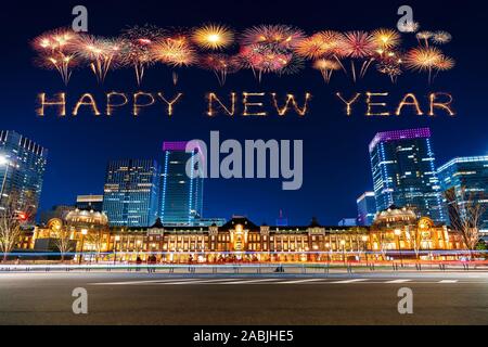 Happy New Year fireworks celebrating over Tokyo station at night in Tokyo, Japan Stock Photo