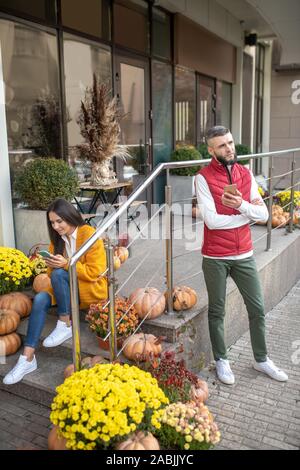Nice young people being engaged in their smartphones Stock Photo