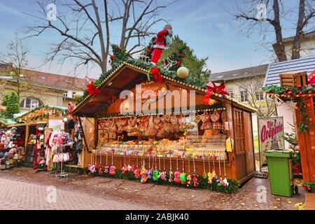 Heidelberg, Germany - November 2019: Sales booth selling colorful sweets during traditional Christmas market in Heidelberg city center Stock Photo