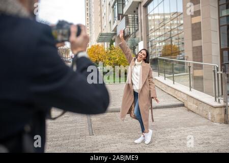 Attractive young woman being photographed by her husband Stock Photo