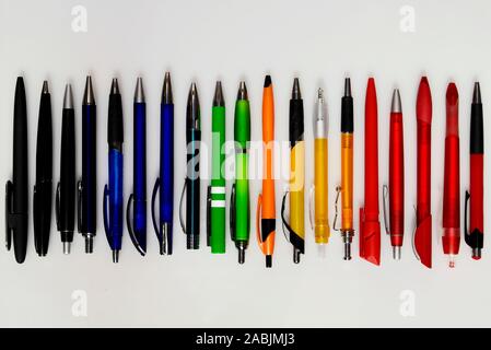An array of colorful plastic pens on a white background Stock Photo