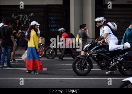 Young protester makes motorbike driver turn around during traffic blocking. Peaceful protests continue one week after the nationwide strike in Cali, C Stock Photo
