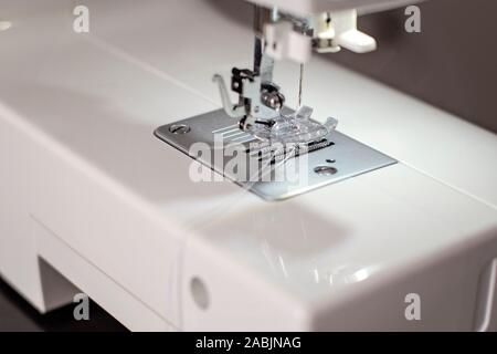 modern sewing machine close-up focused on needle - image Stock Photo