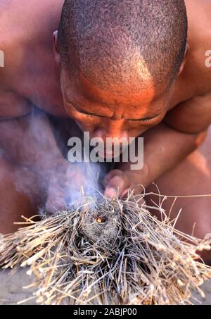 Close up of a bushman making fire in the Kalahari desert. Botswana Stock Photo