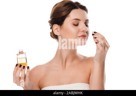 happy woman holding glass bottle and smelling perfume isolated on white Stock Photo