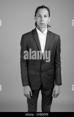Young businessman with dreadlocks wearing suit in black and white Stock Photo