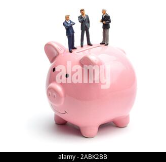 Group of businessmen share profits and savings. People in suits are standing on a piggy bank. Isolated on a white background. Stock Photo