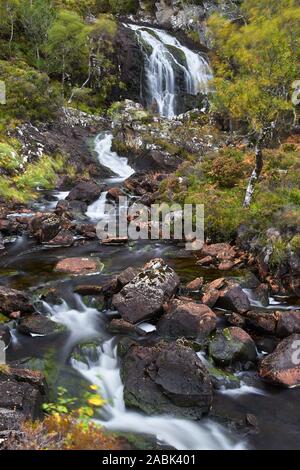 Waterfall on the Allt Ghamhna, Quinag, Assynt, Sutherland, Highland, Scotland. Trees and water blur Stock Photo