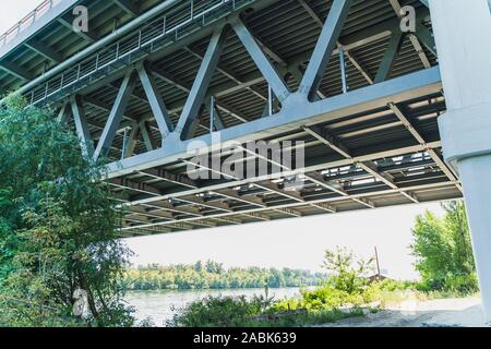 Steel bridge structure, view from below and close up. Big bridge construction across the river in summer, Kiev, Ukraine. Horizontal image Stock Photo