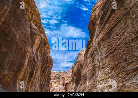 Canyon in the sandy rocks of Petra overlooking the blue sky. The ancient Nabataean city in Jordan. Stock Photo