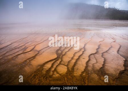 Smoke covered pattern orange pond of Grand Prismatic Spring, famous geyser basin in Yellowstone National Park, Wyoming, USA.