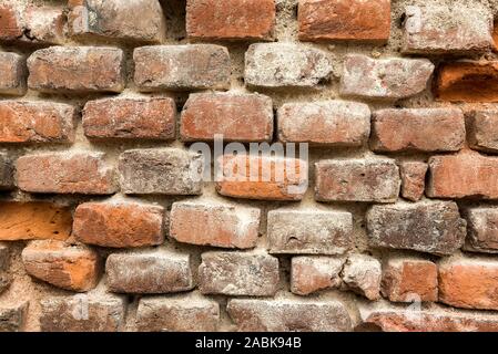 Old and partially damaged brick wall textured background Stock Photo