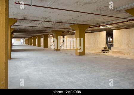 Eindhoven, The Netherlands, June 14th 2016. A big empty industrial former storage space with ocher beams from a the Philips factory, the Veemgebouw at Stock Photo