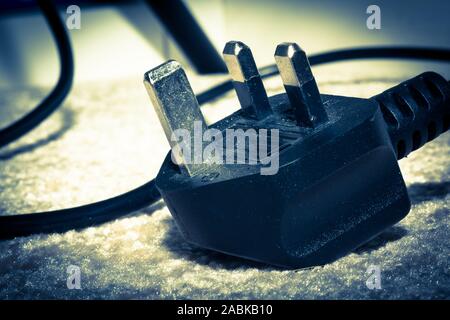 UK power plug isolated on dark blue background Stock Photo