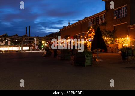 Eindhoven, The Netherlands, June 19th 2019. A view of the Ketelhuis restaurant and bar with colored lights at upcoming urban district Strijp S in the Stock Photo