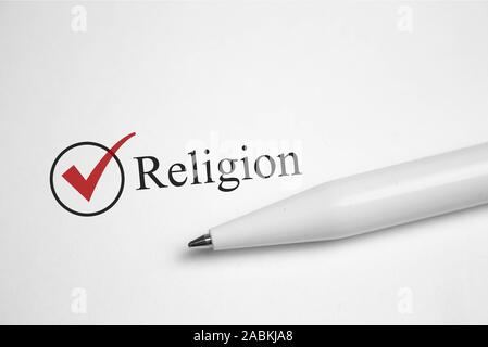 Religion. Filling in the questionnaire, documents. The checkboxes are filled with a red pen on a white background. Questionnaire Stock Photo