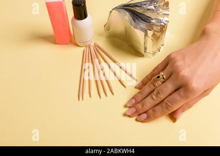Hybrid manicure removal kit. The procedure for removing varnish from nails in progress Stock Photo