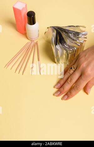 Hybrid manicure removal kit. The procedure for removing varnish from nails in progress Stock Photo