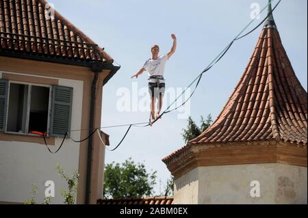 Slackline world record holder Lukas Irmler balances with book at the five-day literature festival 'White Ravens Festival' of the International Youth Library on the courtyard of Schloss Blutenburg. [automated translation] Stock Photo