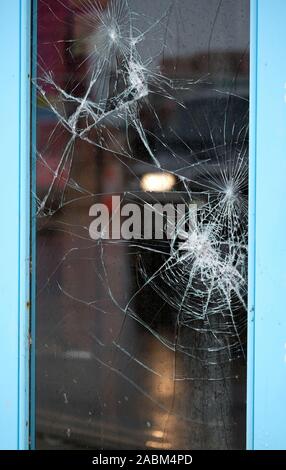 Broken safety glass in public house window. Stock Photo